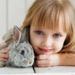 little girl with a pet rabbit