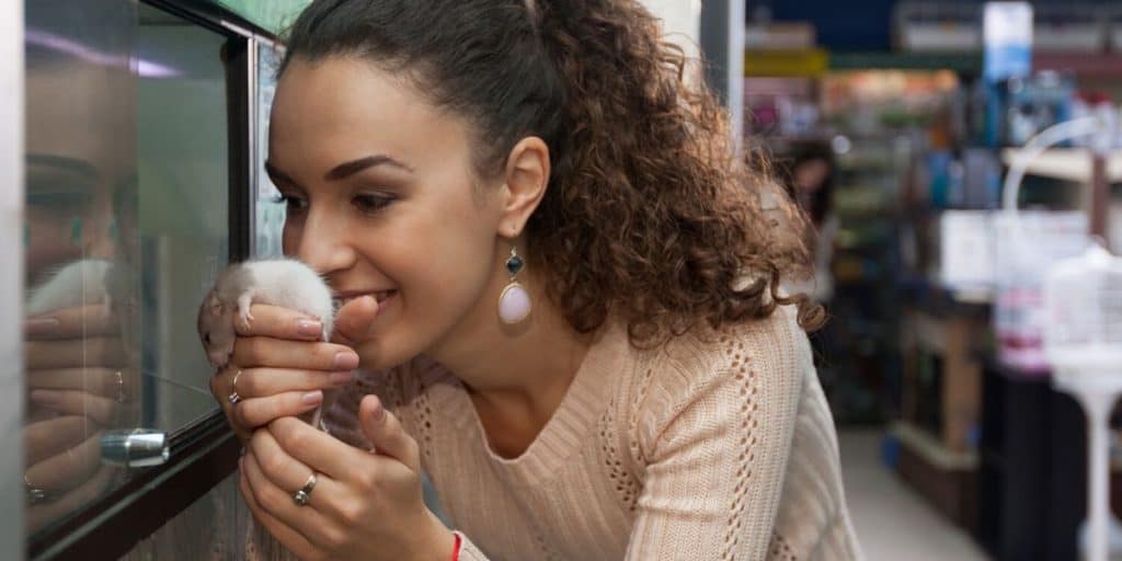 lady smelling a pet mouse